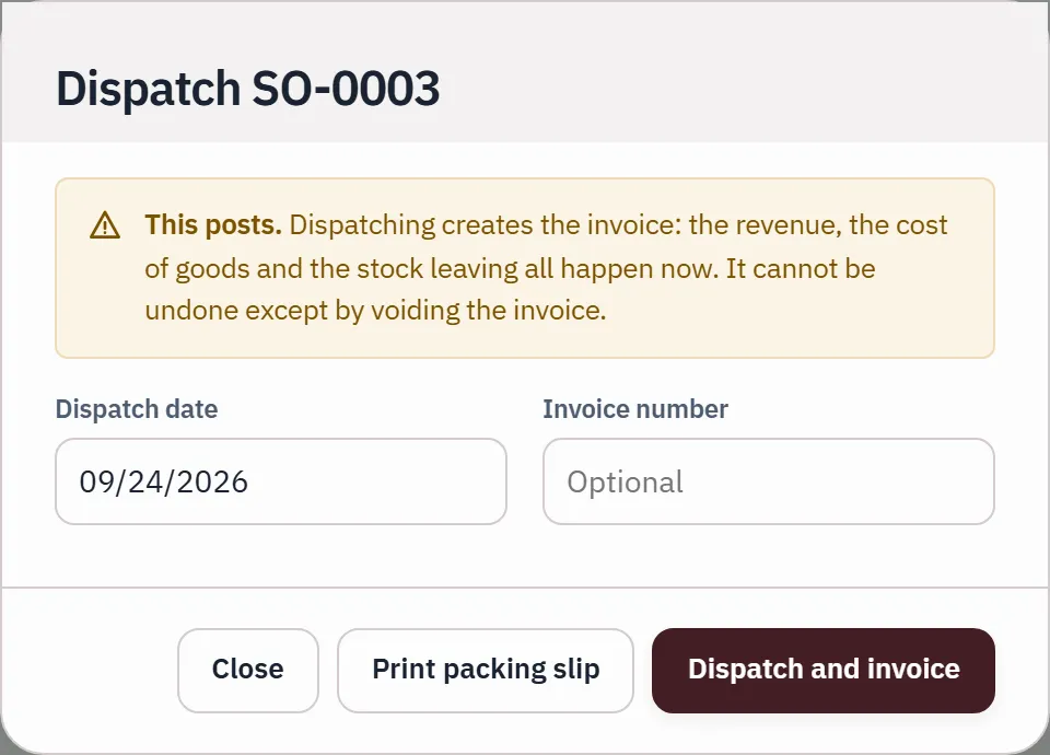 Dispatching SO-0003: a banner says dispatch creates the invoice, and revenue, cost of goods and stock leaving all happen at that moment.