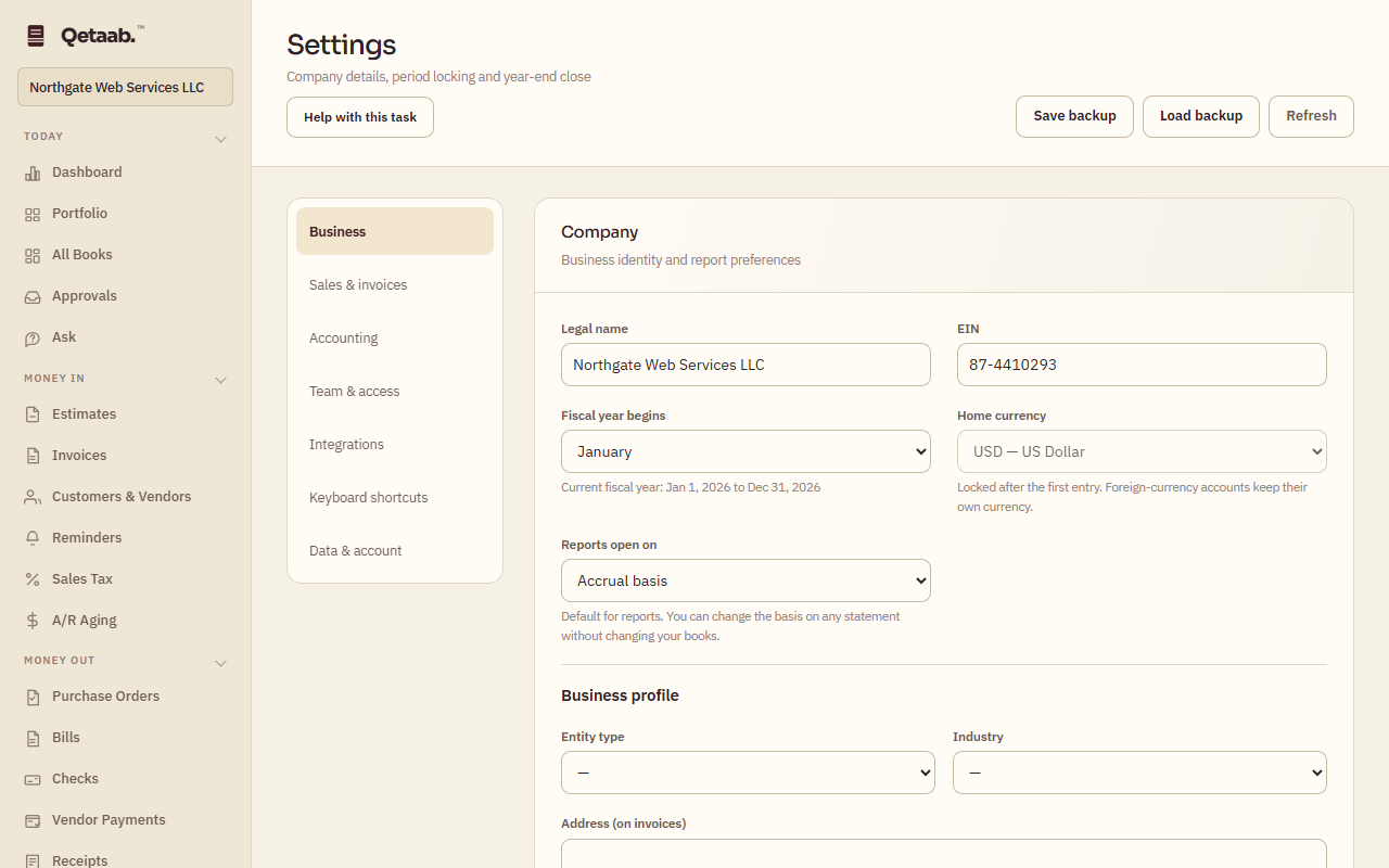 The Settings screen on the Business section. A left list offers Business, Sales & invoices, Accounting, Team & access, Integrations, Keyboard shortcuts and Data & account. The Company card shows Legal name Northgate Web Services LLC, EIN, Fiscal year begins January with the current fiscal year Jan 1, 2026 to Dec 31, 2026, Home currency USD marked locked after the first entry, Reports open on Accrual basis, and the start of the Business profile. The toolbar offers Save backup, Load backup and Refresh.